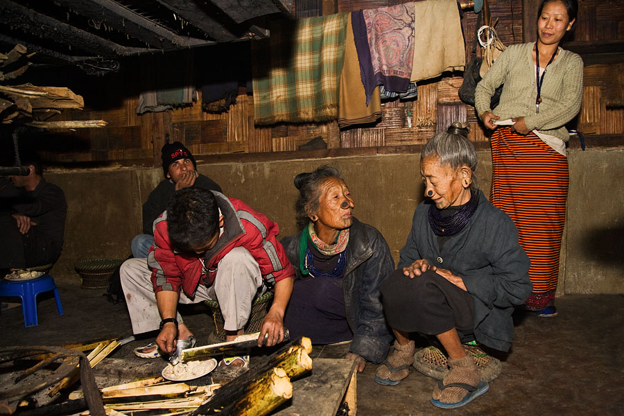  Serving up a typical apatani meal, steamed rice and meat in bamboo trunks